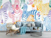 Multicolor zebra wall mural featuring vibrant pink, blue, orange, and yellow zebras on a white background, ideal for modern decor.