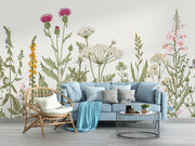 Meadow Bloom Wall Mural featuring delicate wildflowers and lush greenery on a soft-toned background.