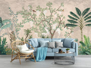 Living room with a light blue sofa, wicker chair, and decorative wall mural featuring plants and birds.