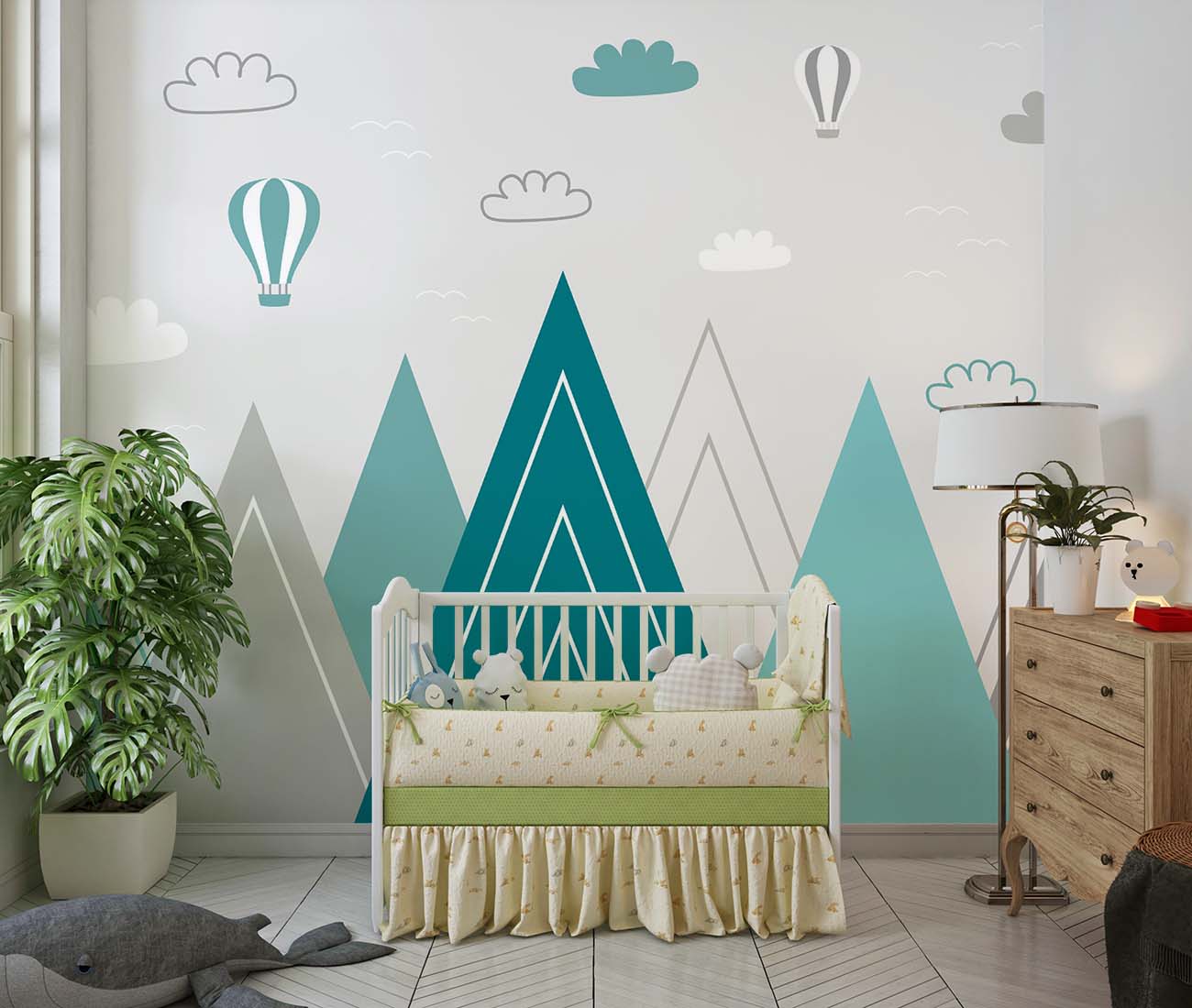 Modern geometric mountain wall mural in teal and grey with hot air balloons and clouds, styled in a contemporary nursery.