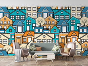 Colorful geometric house wall mural featuring vibrant blue, orange, and beige houses with minimalist trees, creating a modern and lively room atmosphere.