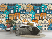 Colorful geometric house wall mural featuring vibrant blue, orange, and beige houses with minimalist trees, creating a modern and lively room atmosphere.