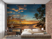 Golden sunset wall mural with palm trees, vibrant sky, and tranquil ocean waves, creating a relaxing and coastal living room ambiance.