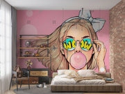 Trendy pop art wall mural featuring a stylish girl with sunglasses and bubble gum on a pink background.