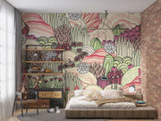 Desert bloom wall mural with hand-drawn cacti, succulents, and rolling hills in pink, green, and cream tones, creating a bold and artistic bedroom backdrop.