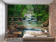 Wall mural of a lush green forest with cascading waterfalls, creating a peaceful ambiance in a modern room.