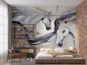Artistic white horses wall mural featuring flowing manes, brushstroke design, and neutral beige, gold, and charcoal tones behind a bed.