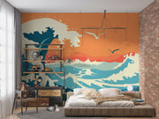 Abstract ocean wave wall mural and wallpaper in vibrant orange and blue tones, styled in a bedroom.