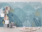 Underwater-themed ocean wall mural featuring fish, seaweed, bubbles, and rolling waves in soft blues and greens. Ideal for kids’ rooms and ocean-inspired interiors.