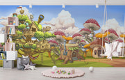 Fantasy wall mural featuring whimsical treehouses, oversized mushrooms, and fairy-tale cottages in a vibrant, enchanted forest setting for kids’ rooms.