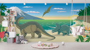 Dinosaur wall mural featuring a scenic beach with a Brachiosaurus, Triceratops, ocean waves, and a soaring Pteranodon at sunset.