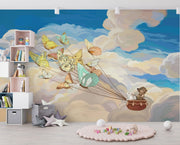A children's room with a whimsical wall mural showcasing butterflies carrying woodland animals across a cloud-filled sky. The room features soft furnishings, wooden toys, and cozy decor elements.