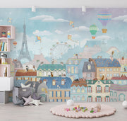 Paris-themed kids’ wall mural with the Eiffel Tower, hot air balloons, colorful rooftops, and kites in soft pastel colors, perfect for a nursery or playroom.