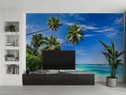 Palm oasis wall mural featuring tall palm trees, white sand, and turquoise waters under a bright blue sky, creating a refreshing workspace atmosphere.