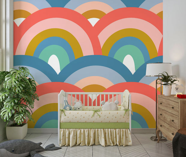 Colorful retro rainbow mural in nursery with white crib and toys.