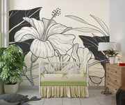 Calm nursery scene with crib and large-scale botanical line art mural in black and cream tones.