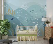 Underwater-themed ocean wall mural featuring fish, seaweed, bubbles, and rolling waves in soft blues and greens. Ideal for kids’ rooms and ocean-inspired interiors.