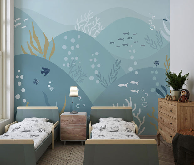 Underwater-themed ocean wall mural featuring fish, seaweed, bubbles, and rolling waves in soft blues and greens. Ideal for kids’ rooms and ocean-inspired interiors.