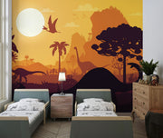 Kids’ dinosaur wall mural featuring silhouettes of Brachiosaurus, Pterosaurs, and prehistoric trees against an orange sunset, ideal for a playful bedroom or playroom.