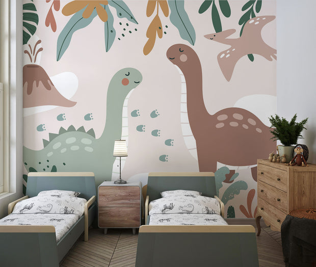 Kids’ wall mural with cartoon dinosaurs, volcano, pterodactyl, and tropical leaves in soft earth tones; styled in a cozy children’s playroom.