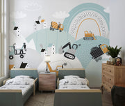 Construction site wall mural with trucks, diggers, and cranes in a pastel blue and orange theme, ideal for kids’ room decor.