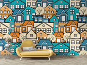 Colorful geometric house wall mural featuring vibrant blue, orange, and beige houses with minimalist trees, creating a modern and lively room atmosphere.