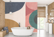 Earthy geometric wall mural with abstract curved shapes in green, ochre, navy, and blush, creating a modern and minimalist bedroom atmosphere.