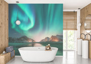 Northern lights wall mural featuring green and blue auroras over snowy mountains and a frozen lake, creating a mesmerizing and tranquil atmosphere.