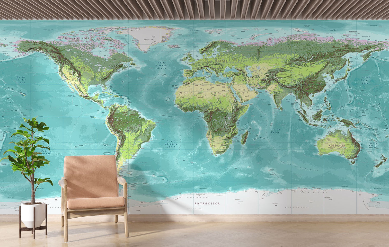 High-detail oversized world map wall mural showing terrain relief and ocean depths in turquoise and green, styled with modern furniture.