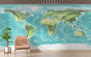 High-detail oversized world map wall mural showing terrain relief and ocean depths in turquoise and green, styled with modern furniture.
