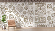 Modern tribal geometric wall mural in gold and white with abstract patterns, styled in contemporary living room with blush chair.