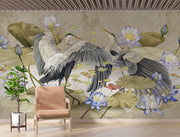 A sophisticated living room featuring an Elegant Heron & Lotus Pond Wall Mural with elegant birds in mid-flight, soft-toned lotus flowers, and floating lily pads. A neutral-coloured linen wooden armchair,  nature-inspired ambience.