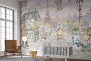 A whimsical Paris-inspired nursery wall mural featuring teddy bears on scooters and bikes, cobblestone streets, and the Eiffel Tower in pastel tones.