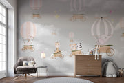 Whimsical hot air balloon animal wall mural featuring giraffes, pandas, elephants, and bears floating in the sky with soft pastel clouds – perfect for kid's rooms and nurseries.