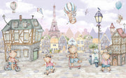 A whimsical Paris-inspired nursery wall mural featuring teddy bears on scooters and bikes, cobblestone streets, and the Eiffel Tower in pastel tones.