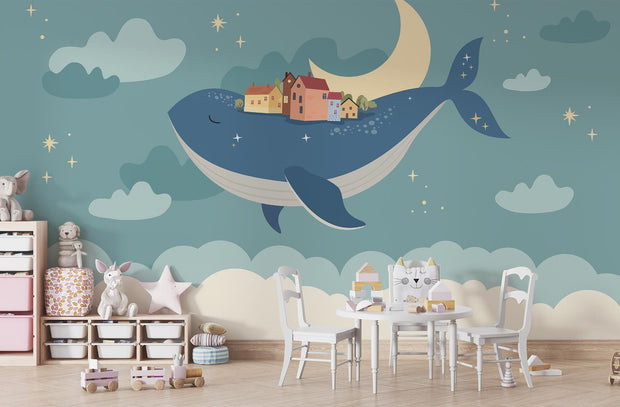 Whale and moon wall mural with a floating village, clouds, and a starry night sky, ideal for kids' rooms and nurseries.