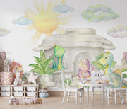 Pastel dinosaur wall mural with soft watercolor-style dinosaurs, a cozy stone cave, lush greenery, and a glowing sun, perfect for nurseries and playrooms.