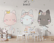 Adorable cat ballerina mural in soft pastel colors, showing three dancing cats in tutus with the phrase "Let's Dance" above them, decorating a children’s play area.
