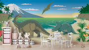 Dinosaur wall mural featuring a scenic beach with a Brachiosaurus, Triceratops, ocean waves, and a soaring Pteranodon at sunset.