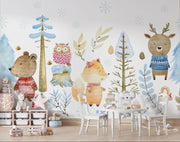 Winter woodland animal wall mural featuring a bear, fox, deer, and owl in cozy knitted sweaters, surrounded by snow-covered trees and soft blue foliage.
