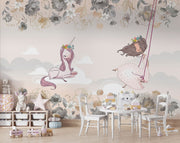 A whimsical nursery wall mural featuring a pink unicorn resting on clouds, a girl swinging with floral details, and soft pastel tones for a dreamy ambiance.