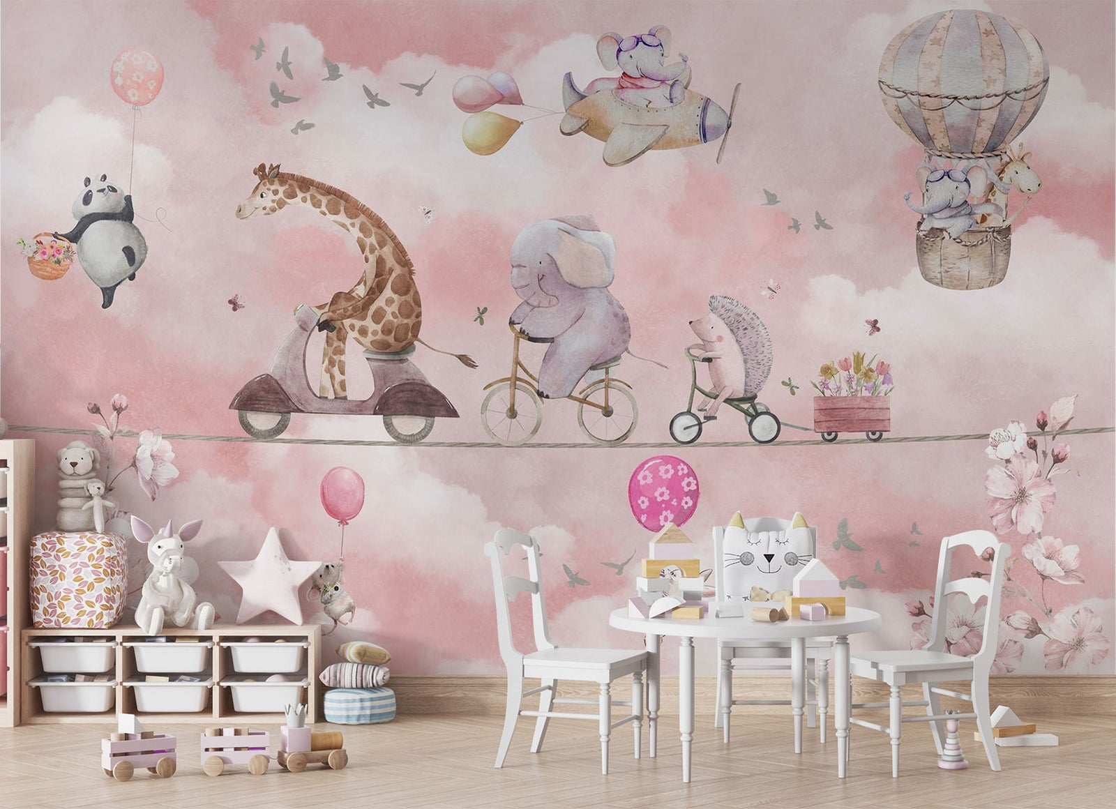 A whimsical nursery wall mural featuring playful animals, including a giraffe on a scooter, an elephant on a bike, and a panda floating with balloons over pink clouds.