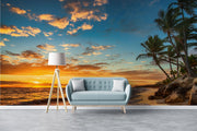 Golden sunset wall mural with palm trees, vibrant sky, and tranquil ocean waves, creating a relaxing and coastal living room ambiance.