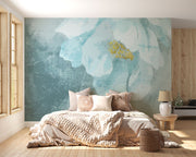 A modern bedroom with a Blue Floral Watercolor Wall Mural, featuring a delicate oversized flower in teal and gold hues. Creating a cosy and elegant space with a soft, artistic ambience.