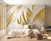 Modern abstract wall mural with golden and beige feather leaf patterns decorating a bedroom.