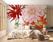 Oversized floral wall mural featuring red, pink, and yellow illustrated blooms with green leaves decorating a modern bedroom.