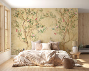 Elegant chinoiserie-style wall mural featuring delicate tree branches, blooming flowers, and colorful birds on a vintage beige background