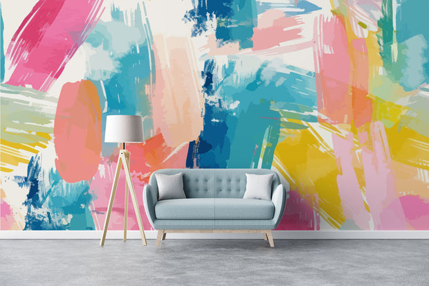 Colorful abstract wall mural with brushstroke patterns in vibrant pink, blue, yellow, and coral shades, installed in a modern living room.