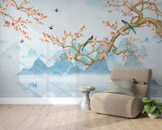 Chinoiserie-style wall mural featuring cherry blossom branches, perched birds, and misty blue mountains, creating a serene and elegant atmosphere.