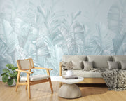 Soft blue palm leaf wall mural featuring oversized banana leaves on a light pastel background, perfect for modern interiors.